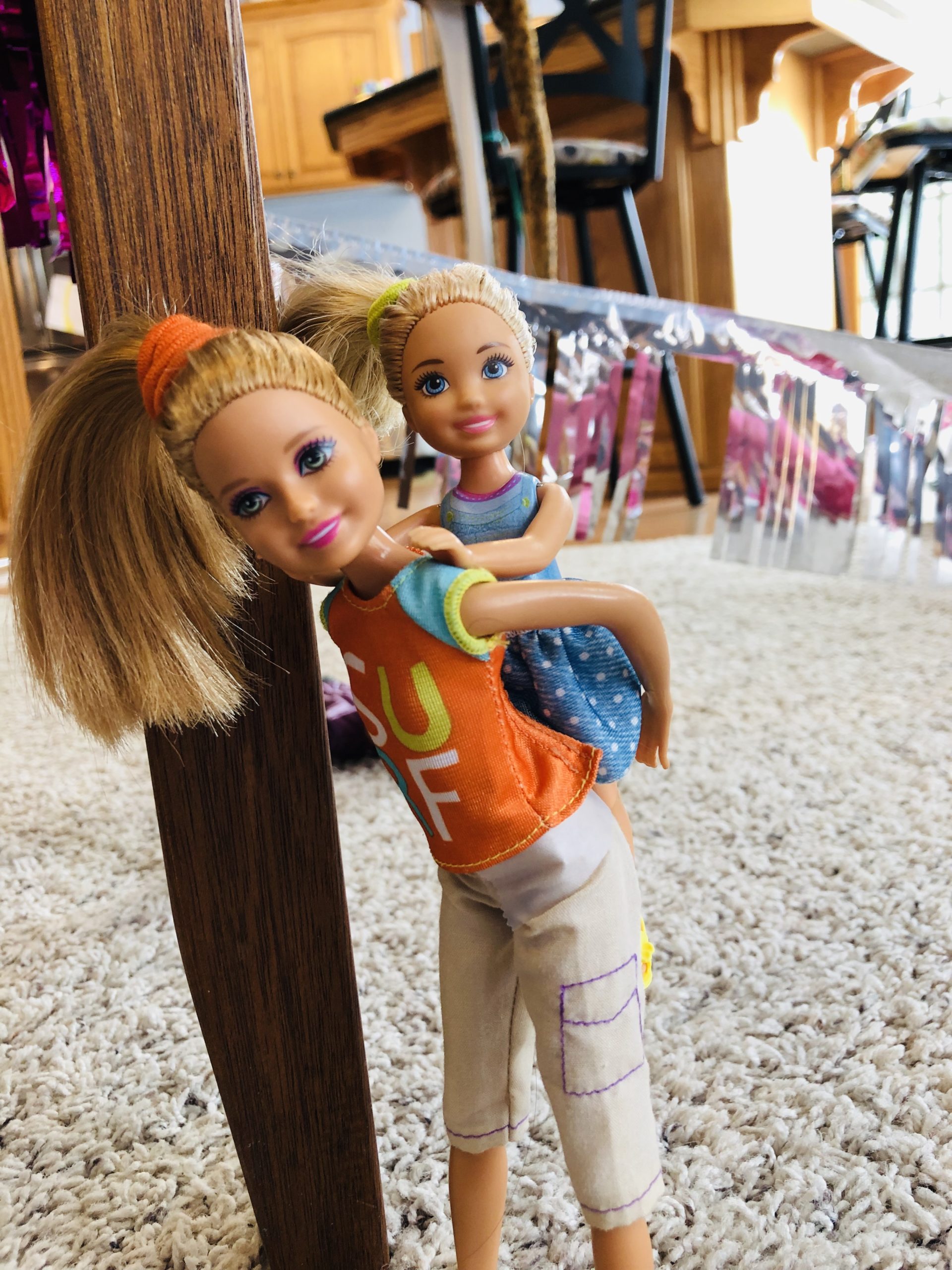 A Stacie Doll (Charlotte) is giving a piggy back ride to Brynn, a Chelsea Doll for a Barbie Doll Story