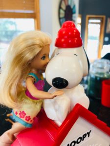 Brynn kissing the Snoopy Snow Cone Machine for the Barbie Story.