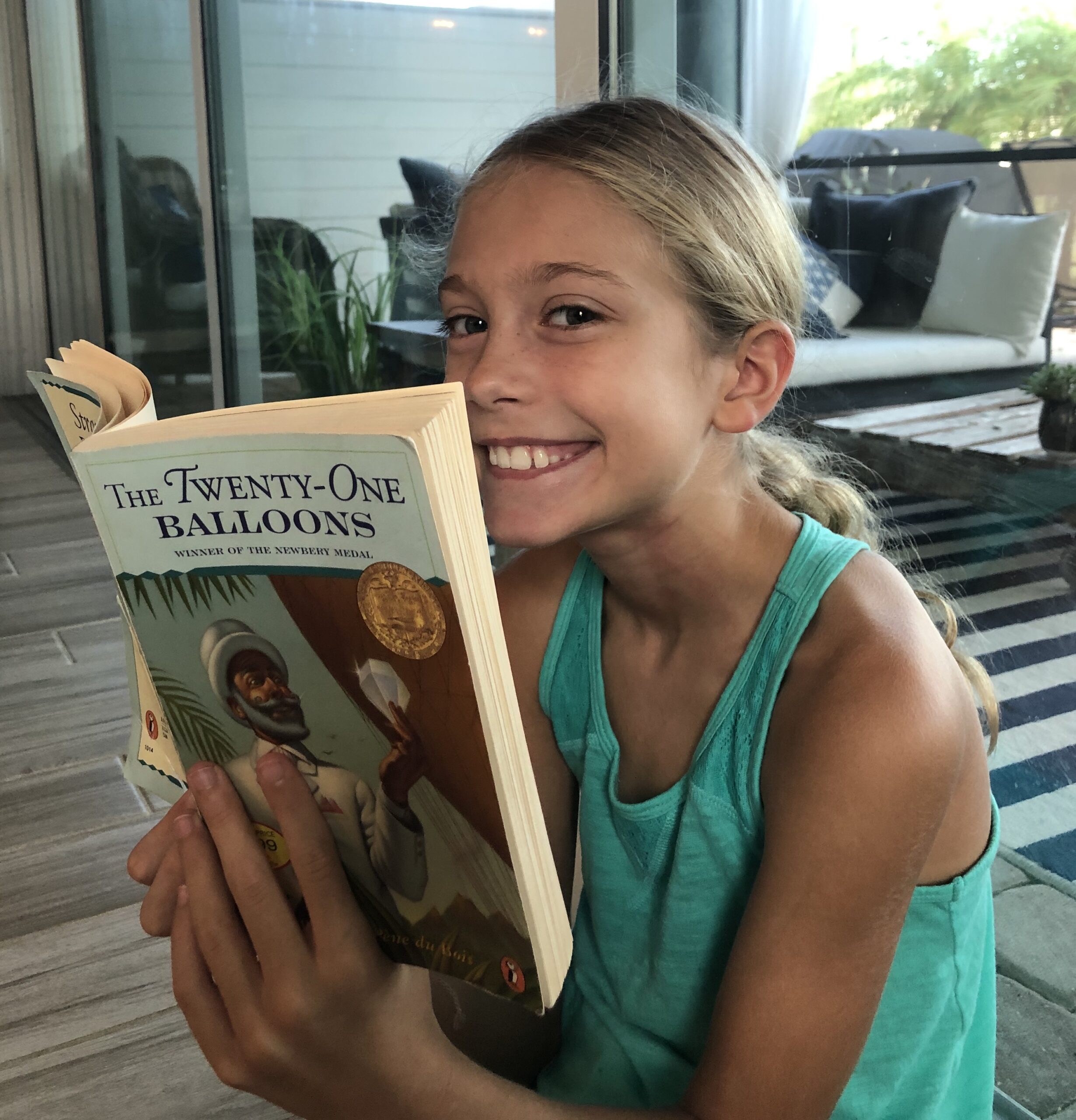 Girl reading 21 Balloons for the Children's Book Review