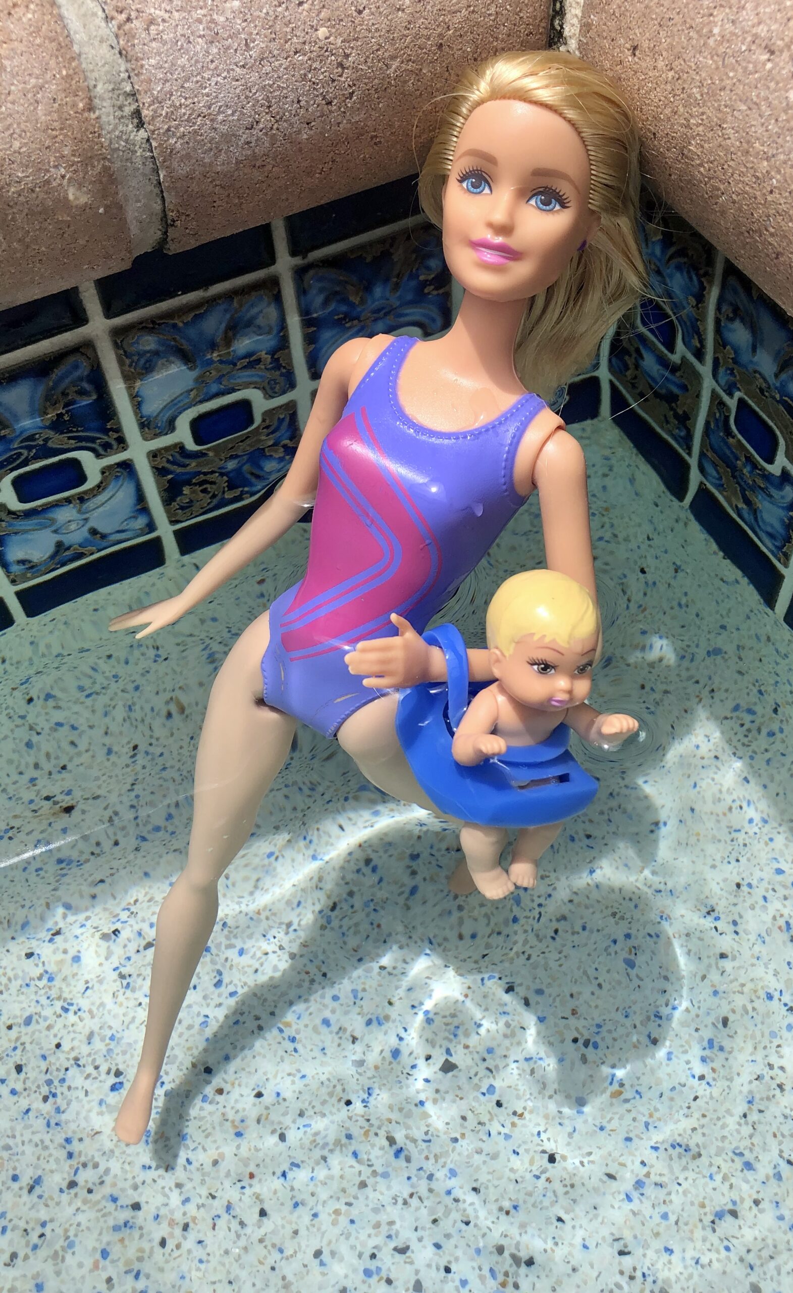 A Barbie and a baby in a pool for the Barbie Doll Story, Goodbye Costa Rica.