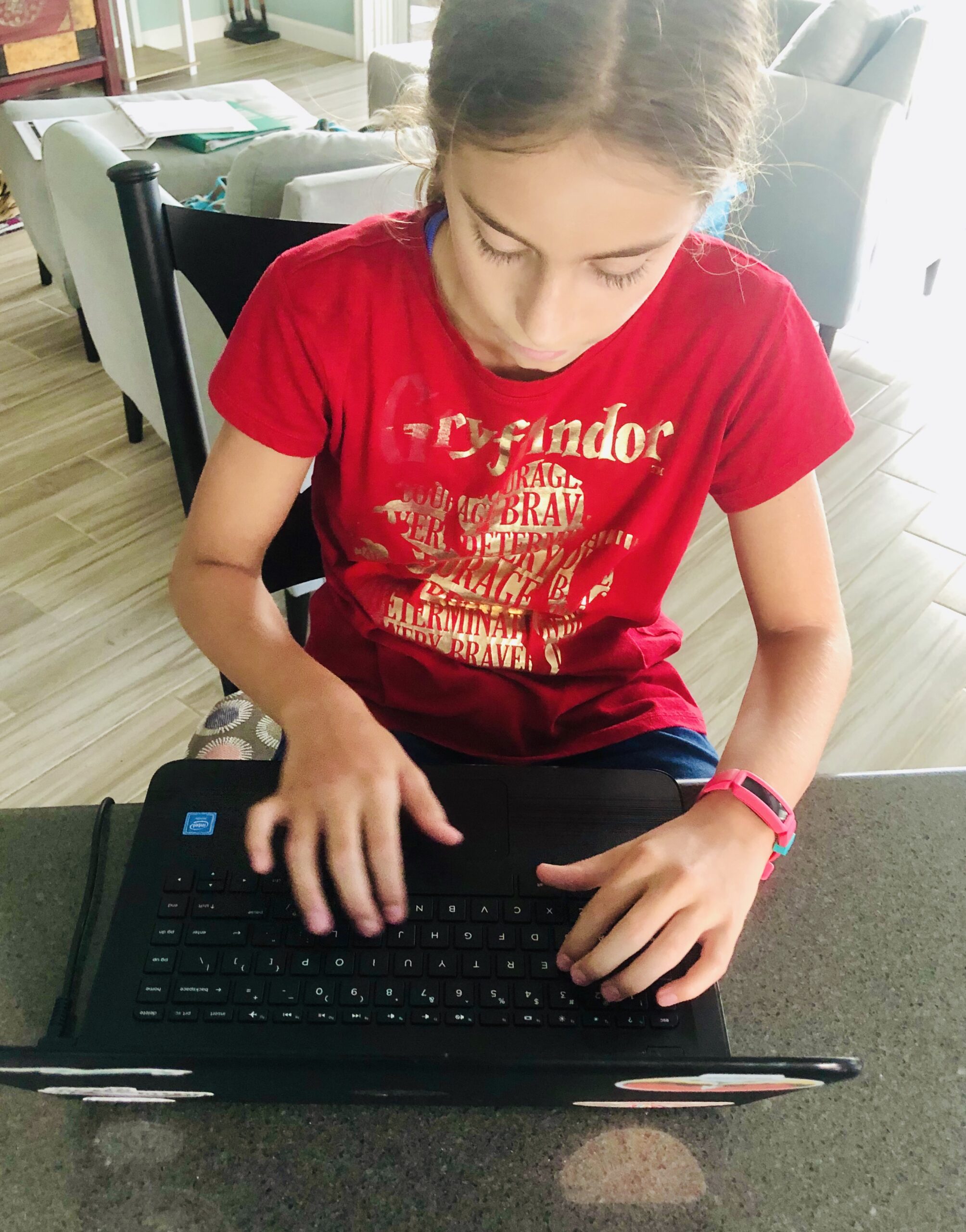Girl typing on a computer.