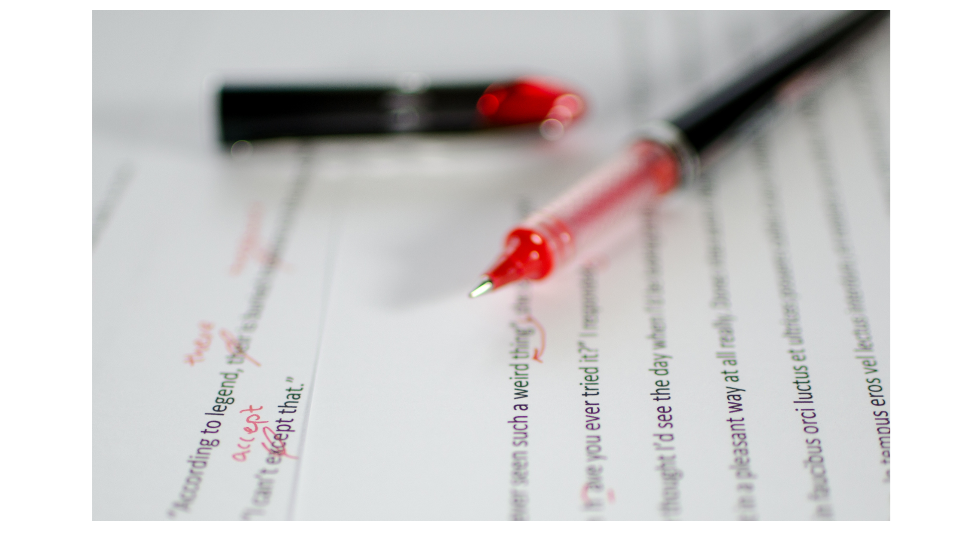 A red pen marking up/editing a paper.