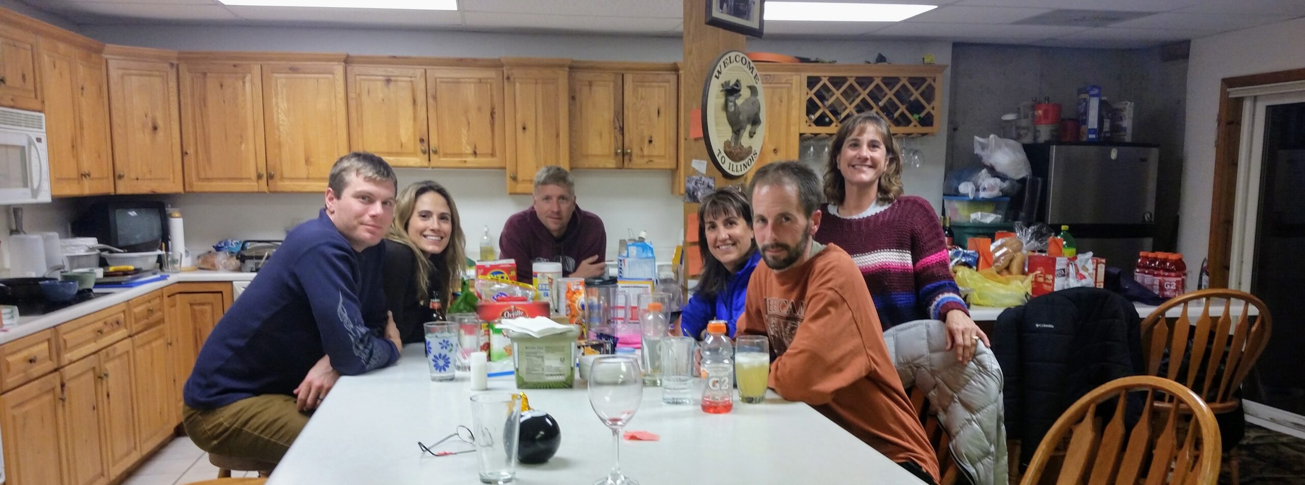 A bunch of people sitting around a kitchen for the holiday story, The Best Thanksgiving Ever!