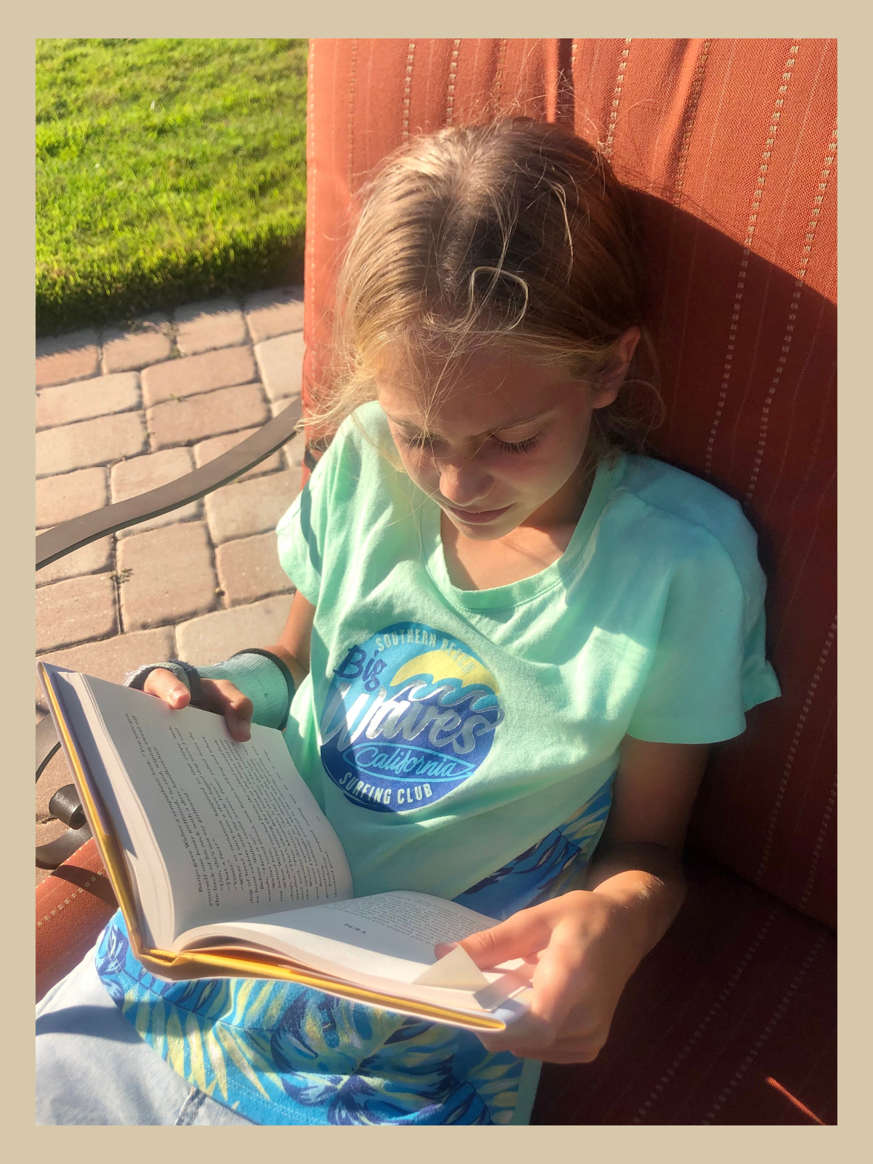 Girl reading a book for the Kids Book Review on Halfway to Harmony.