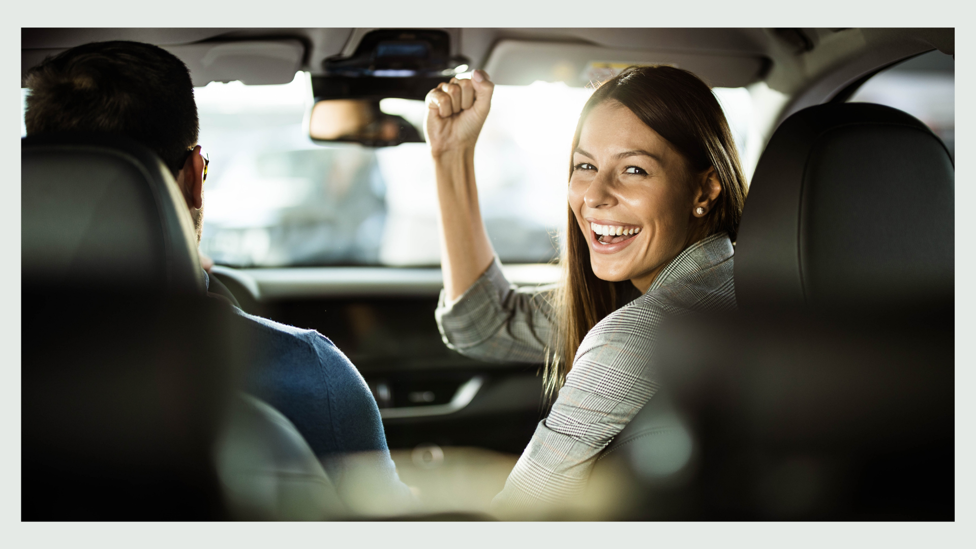 A woman happy in the car.