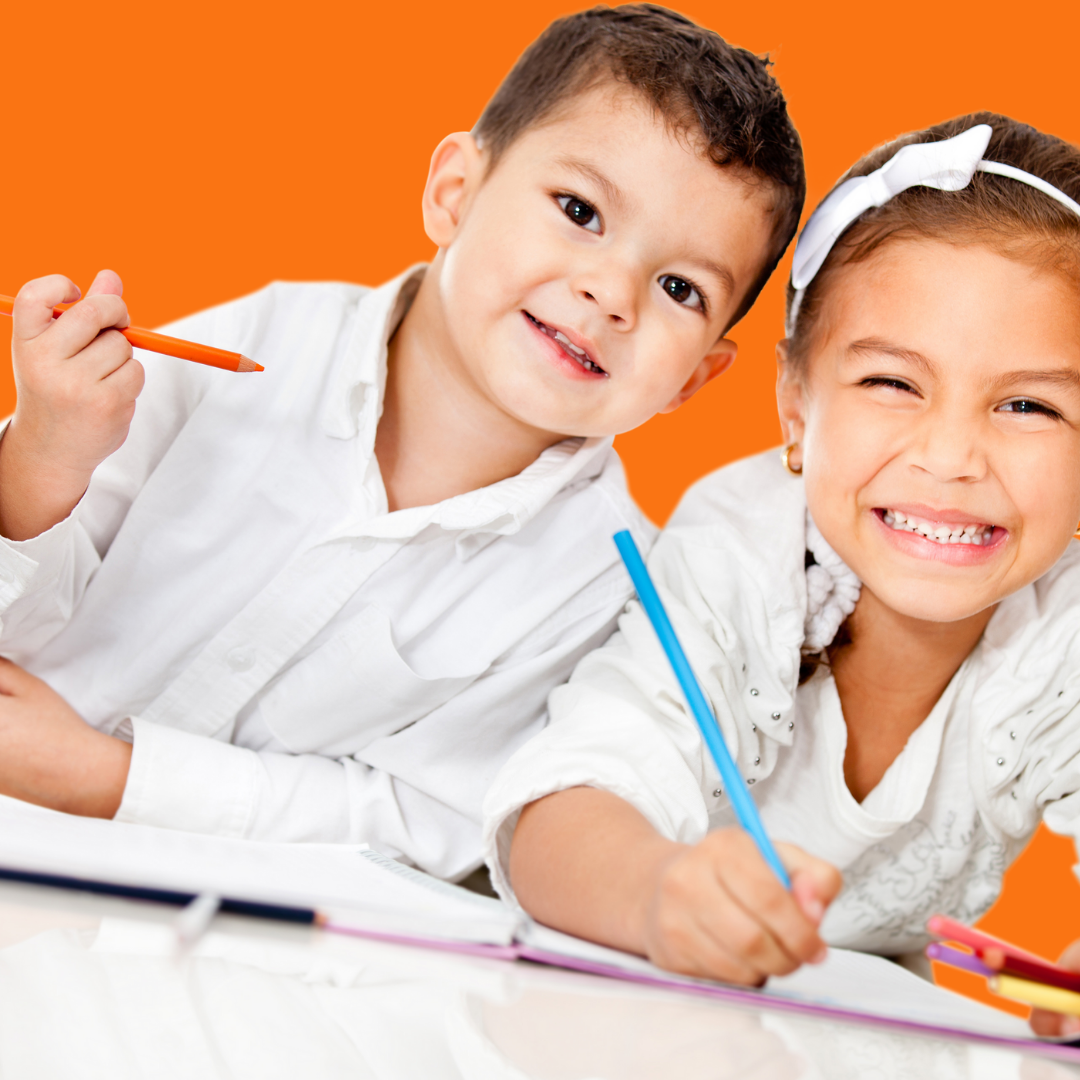 2 kids smiling at the camera taking a break from writing for the article, Summer Writing Ideas for Kids.