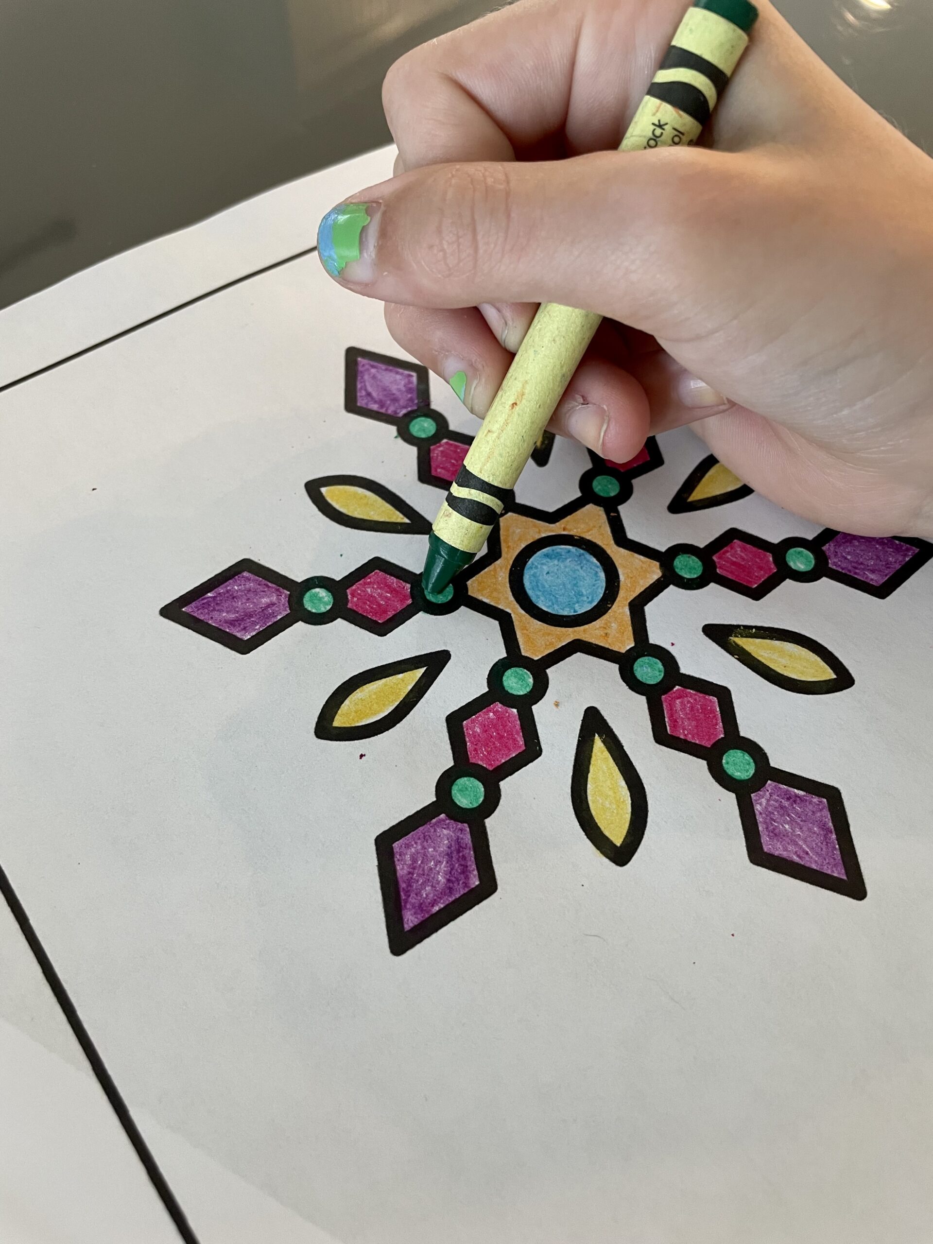 A kid coloring a page from the Spanish Winter Coloring Pages by K and B Life